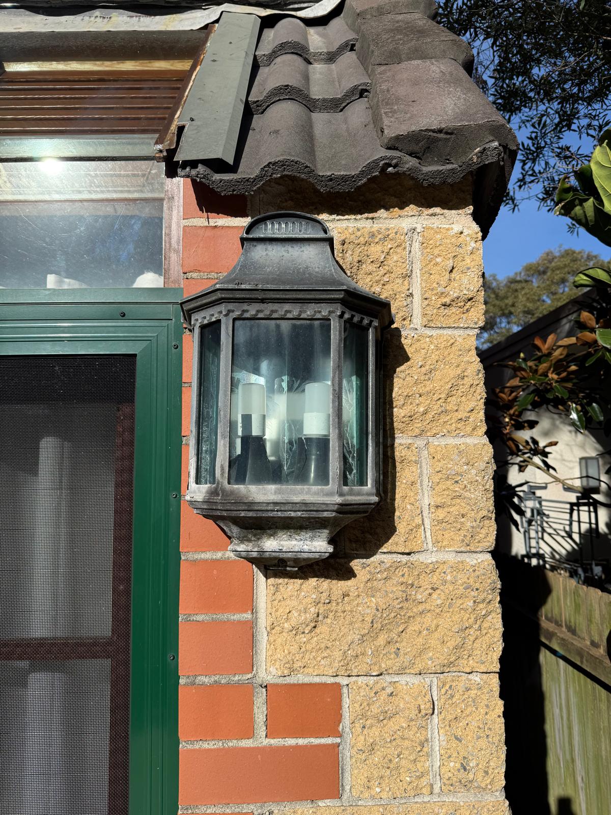 Entry light before — weathered corroded lantern